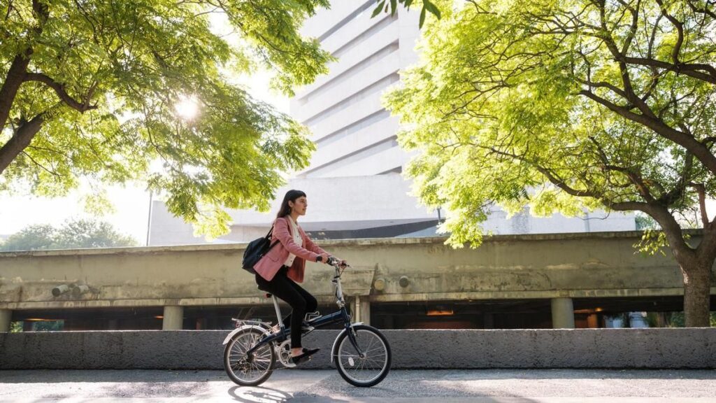 Young woman going to work by bike