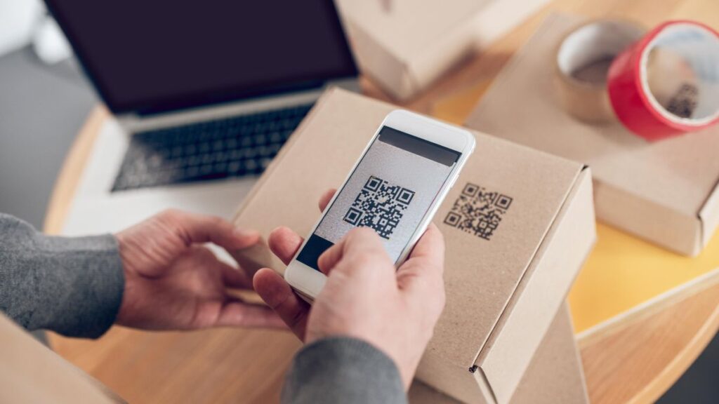 Online store employee scanning information on the product package