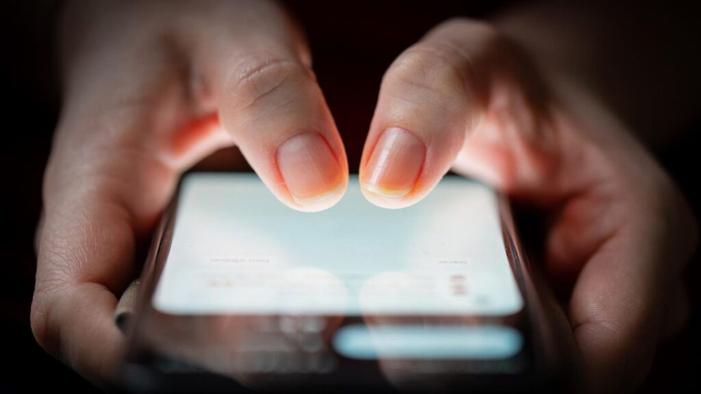 Fingers tapping smartphone screen