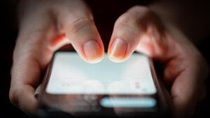 Fingers tapping smartphone screen