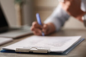 Close up of unrecognizable person signing a contract.