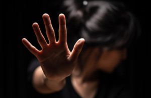 Woman with her hand extended signaling to stop