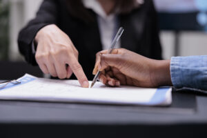 Patient filling in report papers at reception