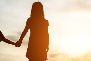 Silhouette of two girl having fun in nature