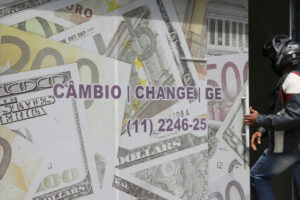 Casa de câmbio decorada com imagens de notas de dólar e de euro, em São Paulo